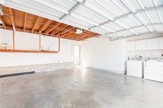 garage with washer and clothes dryer