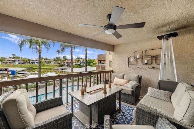 exterior space with a water view, ceiling fan, and an outdoor hangout area
