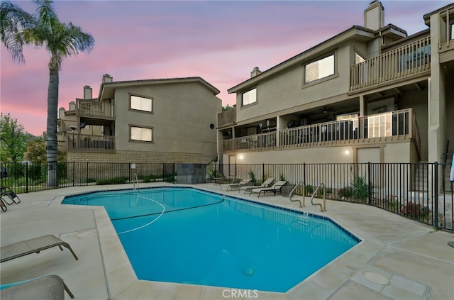 community pool featuring a patio and fence