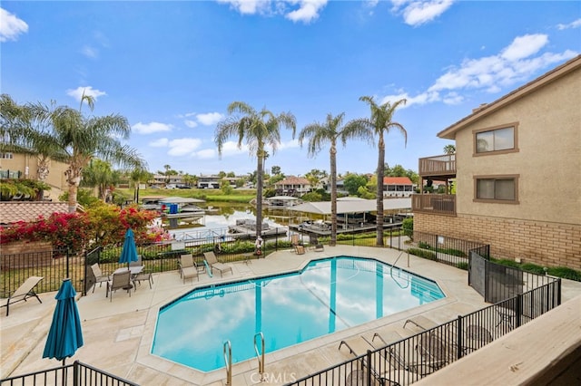 community pool featuring a patio area and fence