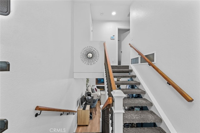 stairs featuring wood finished floors