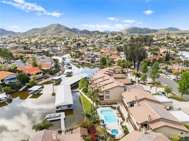 drone / aerial view featuring a residential view and a water and mountain view
