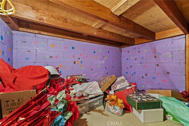 playroom featuring unfinished concrete flooring