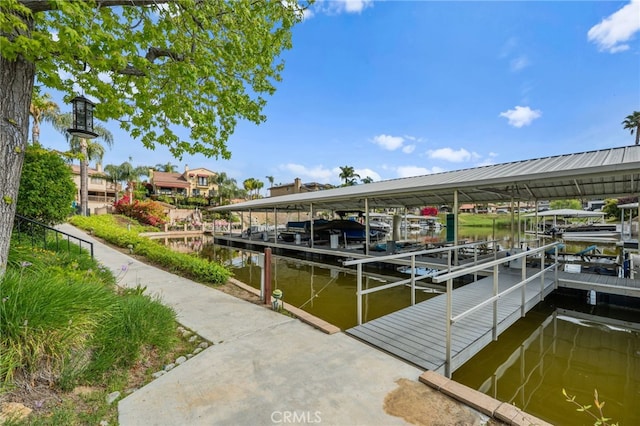 view of dock with boat lift and a water view