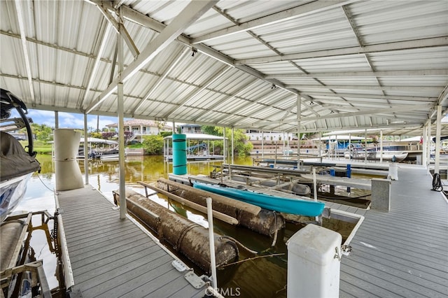 dock area with boat lift and a water view