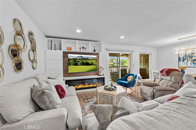 30156 Yellow Feather Dr, Canyon Lake, CA 92587 - living room with a glass covered fireplace, wood finished floors, recessed lighting, a chandelier, and a textured ceiling