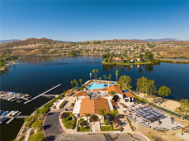 drone / aerial view featuring a water and mountain view