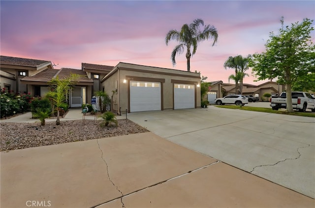 30156 Yellow Feather Dr, Canyon Lake, CA 92587 - view of front of home featuring driveway, stucco siding, and a garage
