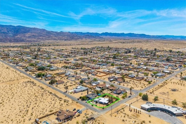 aerial view featuring a mountain view and view of desert