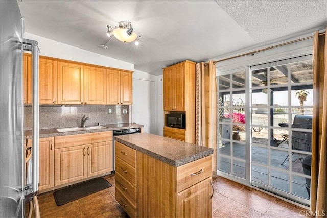 kitchen with high quality fridge, a sink, black microwave, dishwashing machine, and dark tile patterned floors