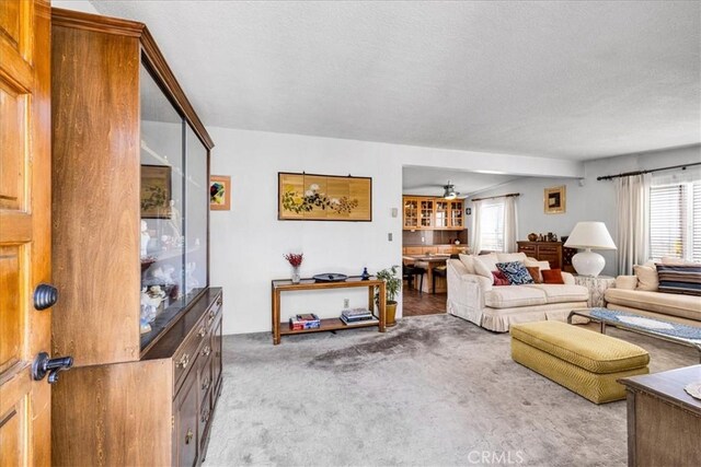5304 Morongo Rd Unit 29, Palms, CA 92277 - living room featuring carpet flooring, a ceiling fan, and a textured ceiling