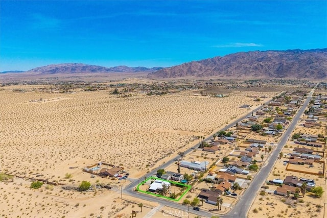 drone / aerial view featuring a mountain view, a rural view, and a desert view