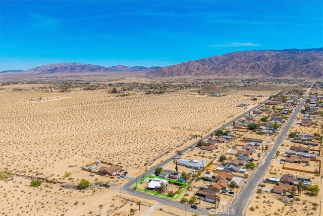 5304 Morongo Rd Unit 29, Palms, CA 92277 - aerial view of property and surrounding area with a mountainous background, property parcel outlined, and a desert landscape