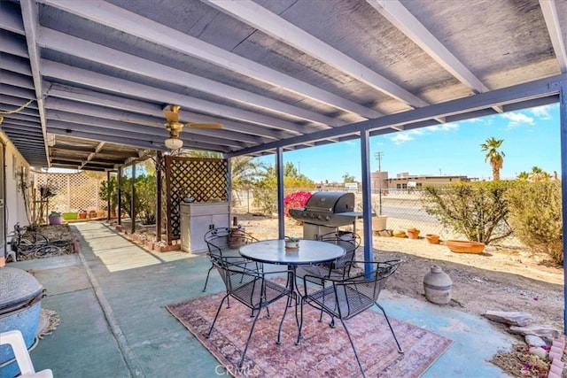 view of patio with fence, outdoor dining space, and grilling area