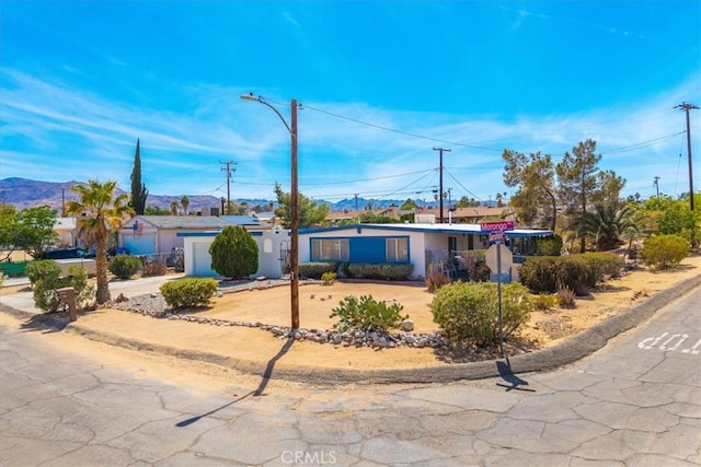 ranch-style home featuring driveway, stucco siding, and an attached garage