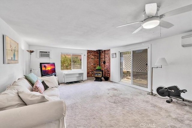carpeted living room with a ceiling fan, an AC wall unit, and a wood stove