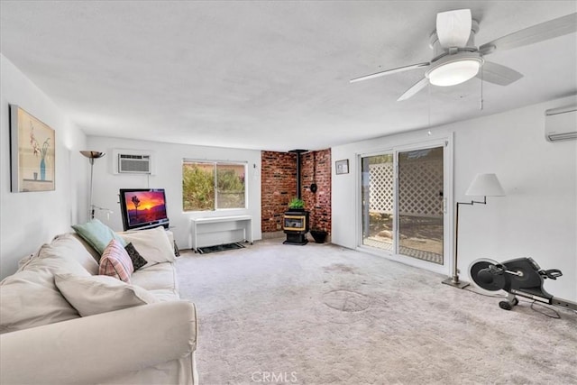 5304 Morongo Rd Unit 29, Palms, CA 92277 - carpeted living room with a wood stove, a wall mounted AC, ceiling fan, and a wall mounted air conditioner