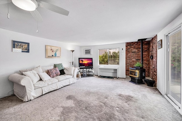5304 Morongo Rd Unit 29, Palms, CA 92277 - living area with a wood stove, plenty of natural light, and carpet floors