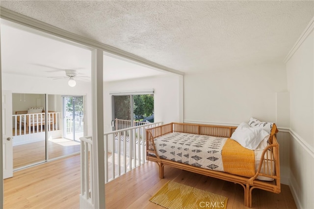 2173 Ranchwood Pl, Riverside, CA 92506 - sitting room featuring a textured ceiling, wood finished floors, a ceiling fan, and ornamental molding
