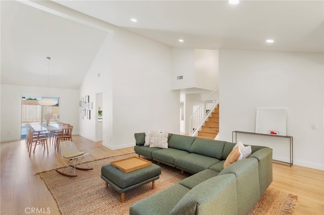 2173 Ranchwood Pl, Riverside, CA 92506 - living room with high vaulted ceiling, light wood-style floors, baseboards, recessed lighting, and stairway