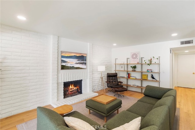 2173 Ranchwood Pl, Riverside, CA 92506 - living room with a brick fireplace, light wood-style floors, and recessed lighting