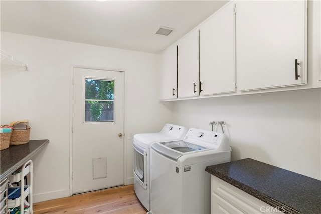 2173 Ranchwood Pl, Riverside, CA 92506 - laundry room with cabinet space, washer and dryer, light wood-type flooring, and baseboards