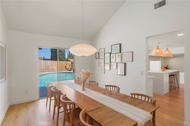 2173 Ranchwood Pl, Riverside, CA 92506 - dining room with light wood-style floors, baseboards, and high vaulted ceiling