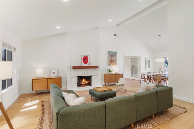 2173 Ranchwood Pl, Riverside, CA 92506 - living room with a fireplace, light wood-type flooring, beamed ceiling, high vaulted ceiling, and baseboards