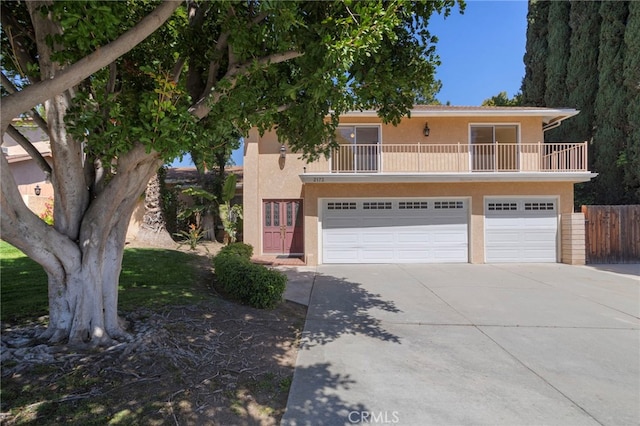 2173 Ranchwood Pl, Riverside, CA 92506 - front facade featuring concrete driveway, stucco siding, a garage, and a balcony