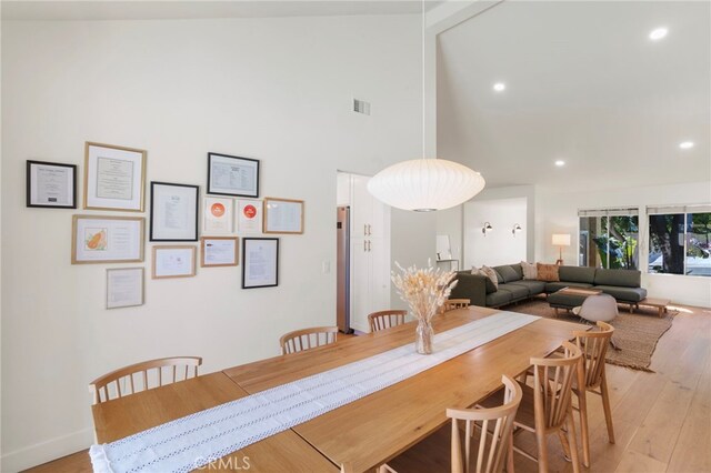 2173 Ranchwood Pl, Riverside, CA 92506 - dining room featuring light wood-style floors, recessed lighting, a towering ceiling, and baseboards