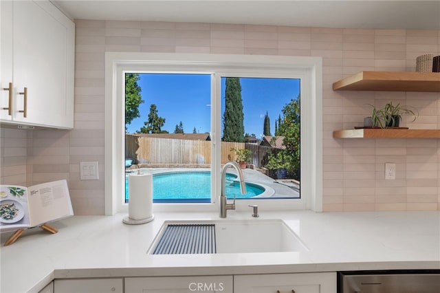 2173 Ranchwood Pl, Riverside, CA 92506 - kitchen with a sink, stainless steel dishwasher, tasteful backsplash, and white cabinets