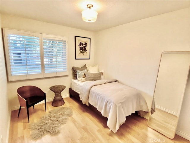 22521 Caminito Esteban Unit 23, Laguna Hills, CA 92653 - bedroom featuring light wood-style floors and baseboards
