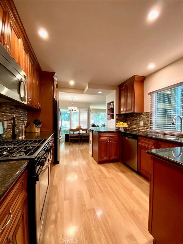 22521 Caminito Esteban Unit 23, Laguna Hills, CA 92653 - kitchen featuring appliances with stainless steel finishes, a sink, light wood finished floors, healthy amount of natural light, and recessed lighting