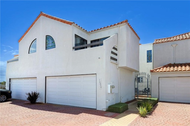 16059 Crete Ln, Huntington Beach, CA 92649 - view of front of property with a garage, stucco siding, decorative driveway, and a tiled roof