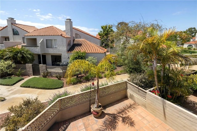 16059 Crete Ln, Huntington Beach, CA 92649 - exterior space with stucco siding, fence, a tiled roof, and a chimney