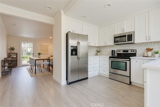 63 Streamwood, Irvine, CA 92620 - kitchen featuring white cabinetry, light wood finished floors, appliances with stainless steel finishes, and light countertops