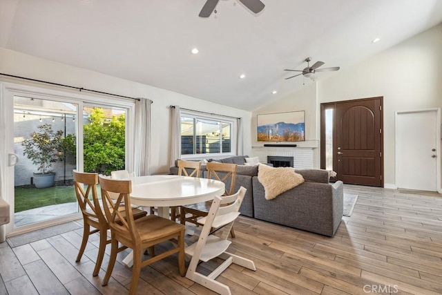 2176 N Pami Cir, Orange, CA 92867 - dining space with light wood-style floors, a fireplace, a ceiling fan, and lofted ceiling
