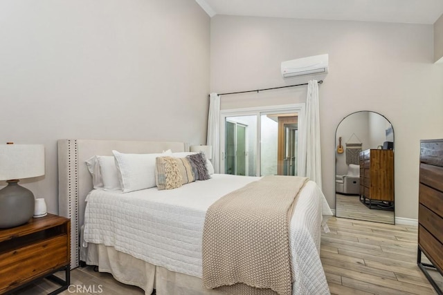 2176 N Pami Cir, Orange, CA 92867 - bedroom featuring light wood-style floors, lofted ceiling, a wall mounted air conditioner, and access to exterior