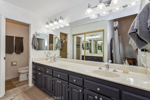 2176 N Pami Cir, Orange, CA 92867 - full bathroom with double vanity, toilet, a sink, and wood finished floors