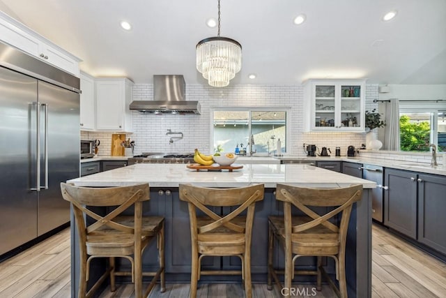 2176 N Pami Cir, Orange, CA 92867 - kitchen with a kitchen island, appliances with stainless steel finishes, wall chimney exhaust hood, and tasteful backsplash