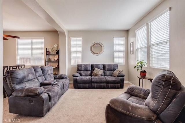 11947 Forest Park Ln, Victorville, CA 92392 - living room with ceiling fan, baseboards, carpet, and a healthy amount of sunlight