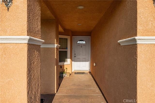 view of exterior entry with stucco siding