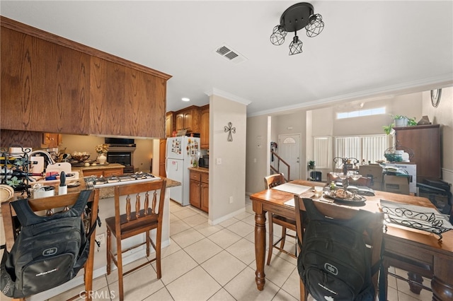 kitchen featuring visible vents, light tile patterned floors, gas stovetop, and freestanding refrigerator
