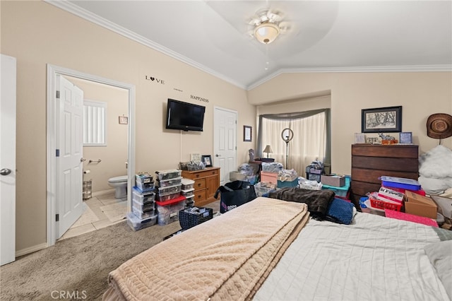 bedroom featuring carpet flooring, connected bathroom, vaulted ceiling, baseboards, and ornamental molding