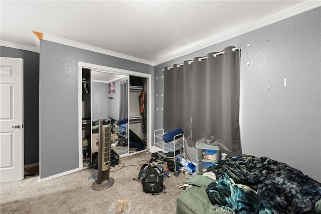 carpeted bedroom featuring crown molding, a closet, and baseboards