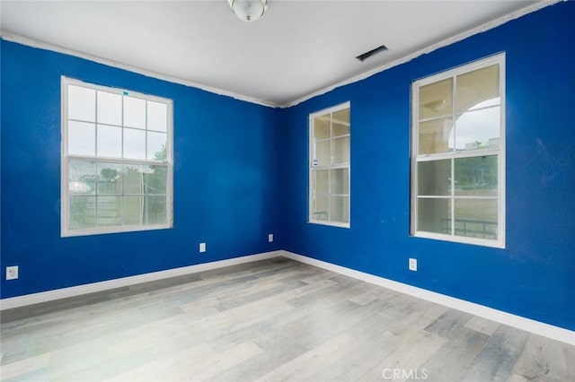 1059 Stowell Ranch Cir, Corona, CA 92881 - unfurnished room with ornamental molding, visible vents, and wood finished floors