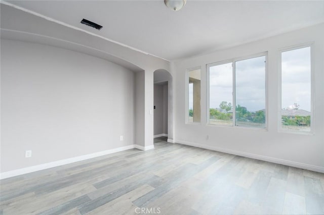 1059 Stowell Ranch Cir, Corona, CA 92881 - unfurnished room with baseboards, wood finished floors, and arched walkways