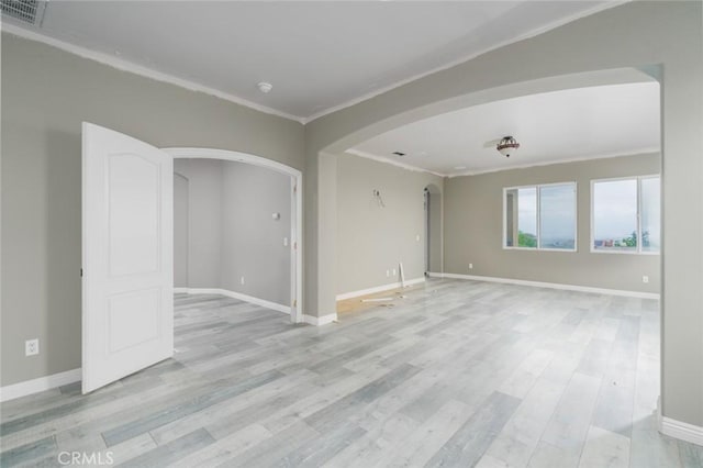 1059 Stowell Ranch Cir, Corona, CA 92881 - spare room with arched walkways, light wood-style flooring, ornamental molding, baseboards, and visible vents