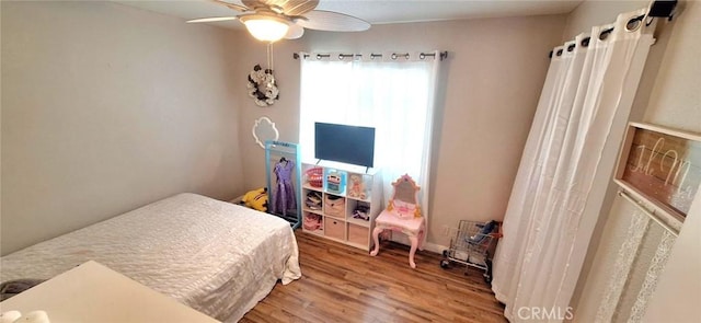 bedroom with wood finished floors and a ceiling fan