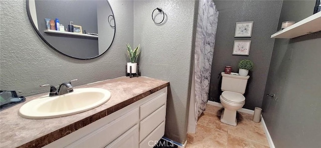full bath with toilet, tile patterned flooring, a textured wall, and vanity